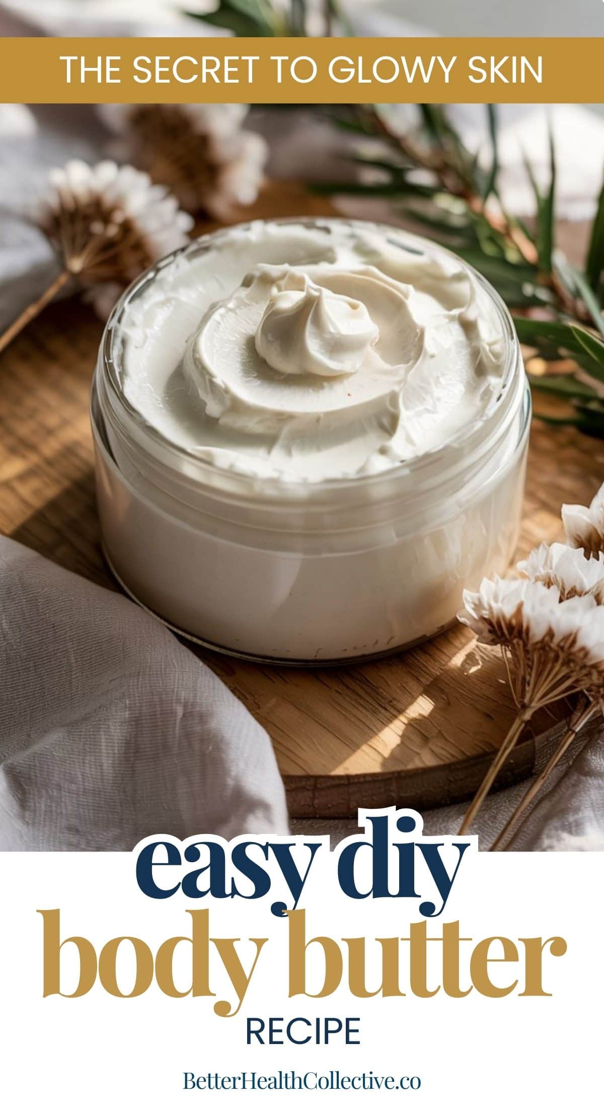 A glass jar filled with DIY body butter sits on a wooden tray, surrounded by dried flowers and a beige cloth. Text reads: The Secret to Glowing Skin. Easy DIY Body Butter Recipe. wellnestguide.com.